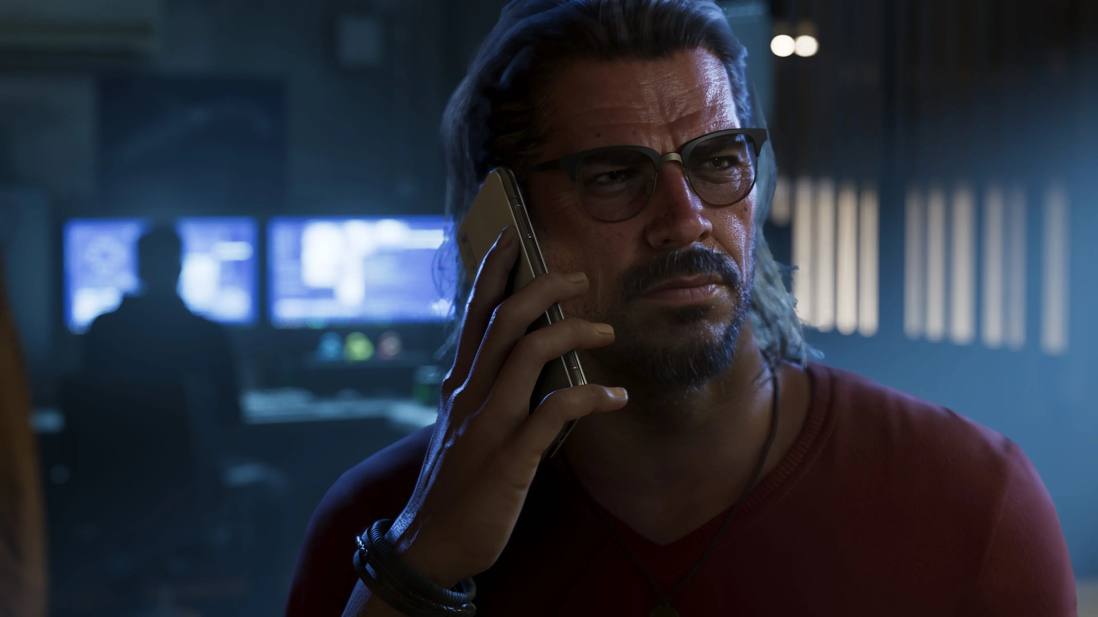 GTA 6 Raul Bautista taking a call in a dim surveillance room